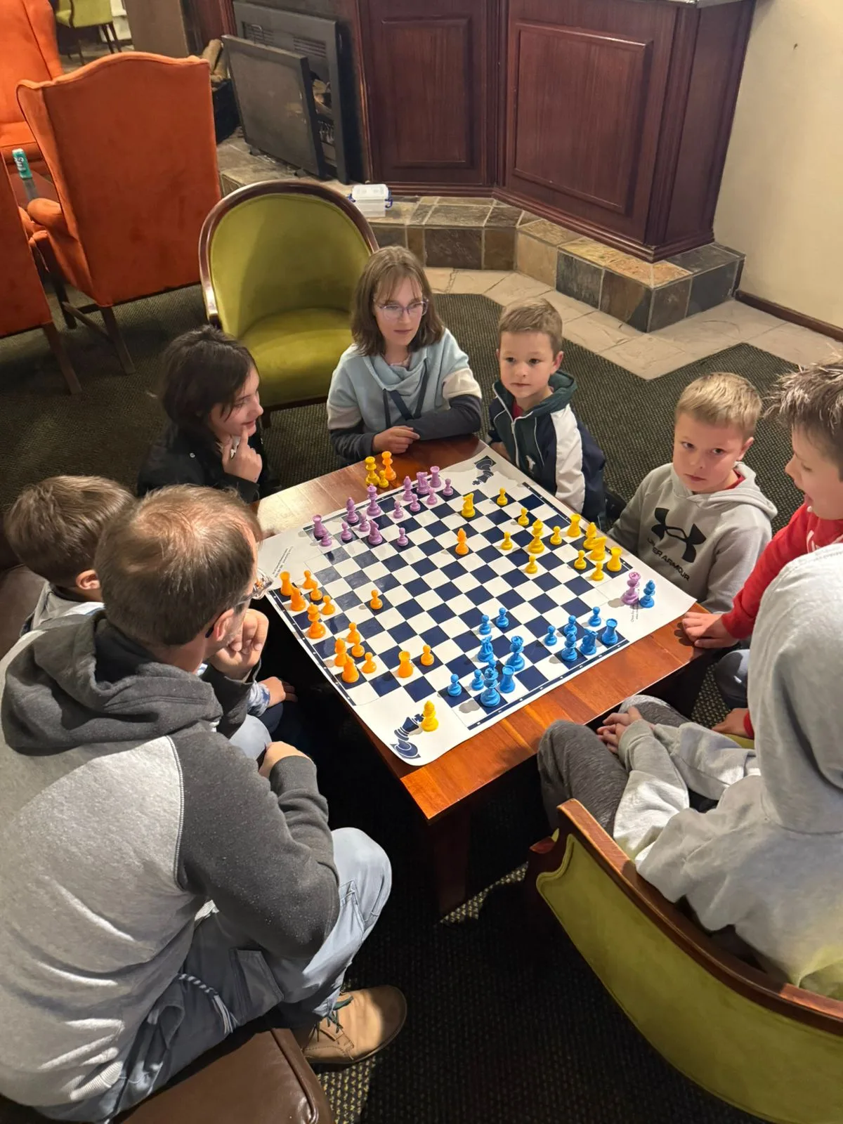 Four players sharing a chess table during club play.